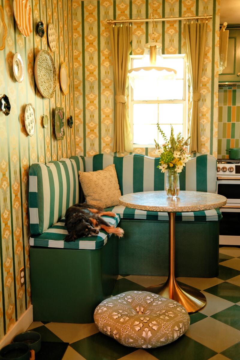 A green and lime banquette in a colorful kitchen