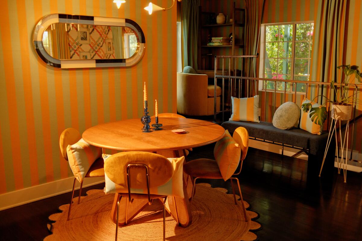 A dining room next to a striped wall