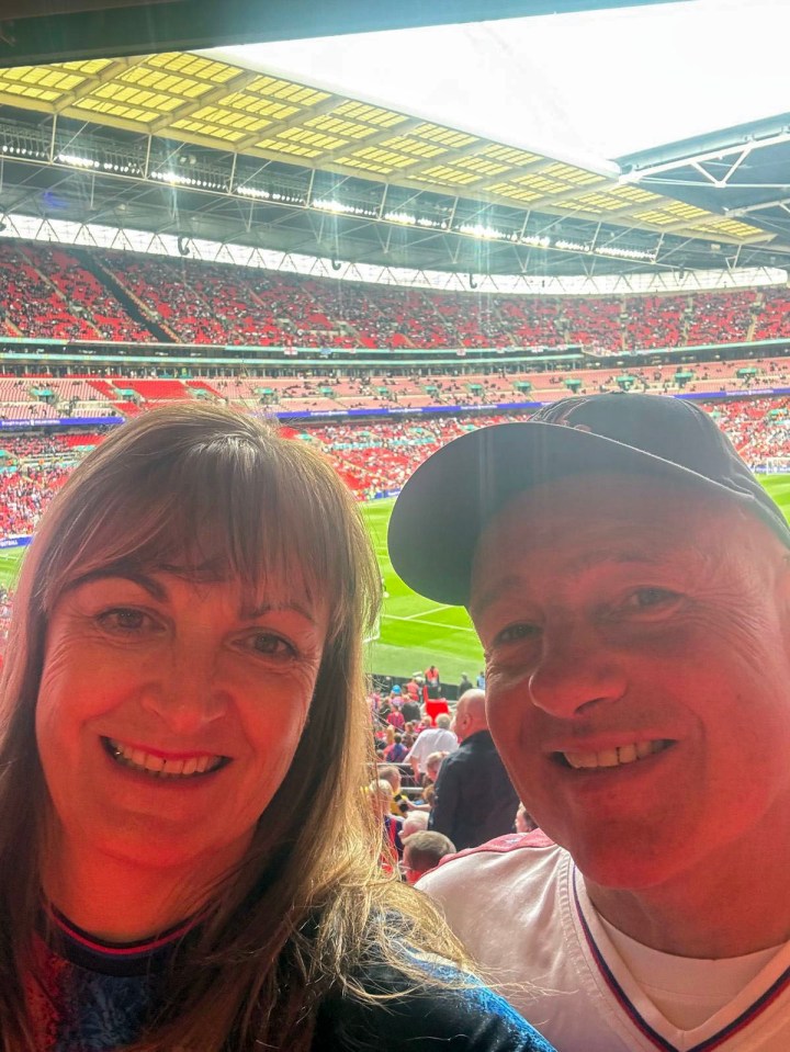 Couple at Wembley Stadium selfie.