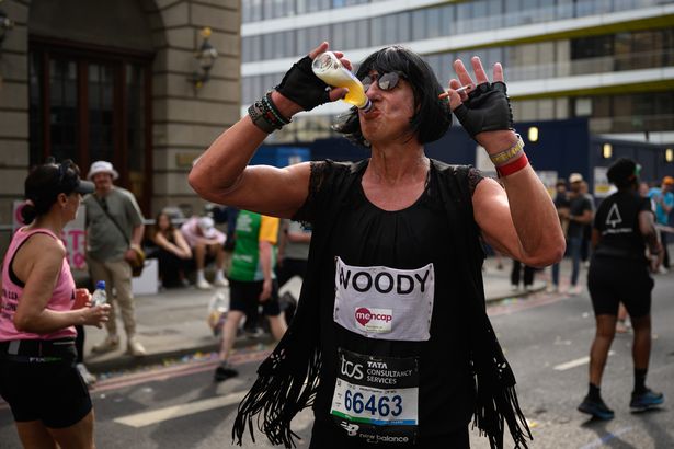 Image of man drinking water during marathon