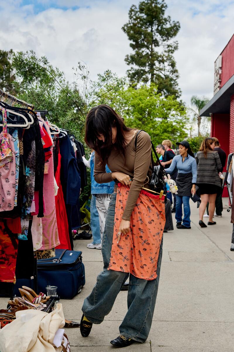 Clockwise from left: A shopper looks at a skirt.