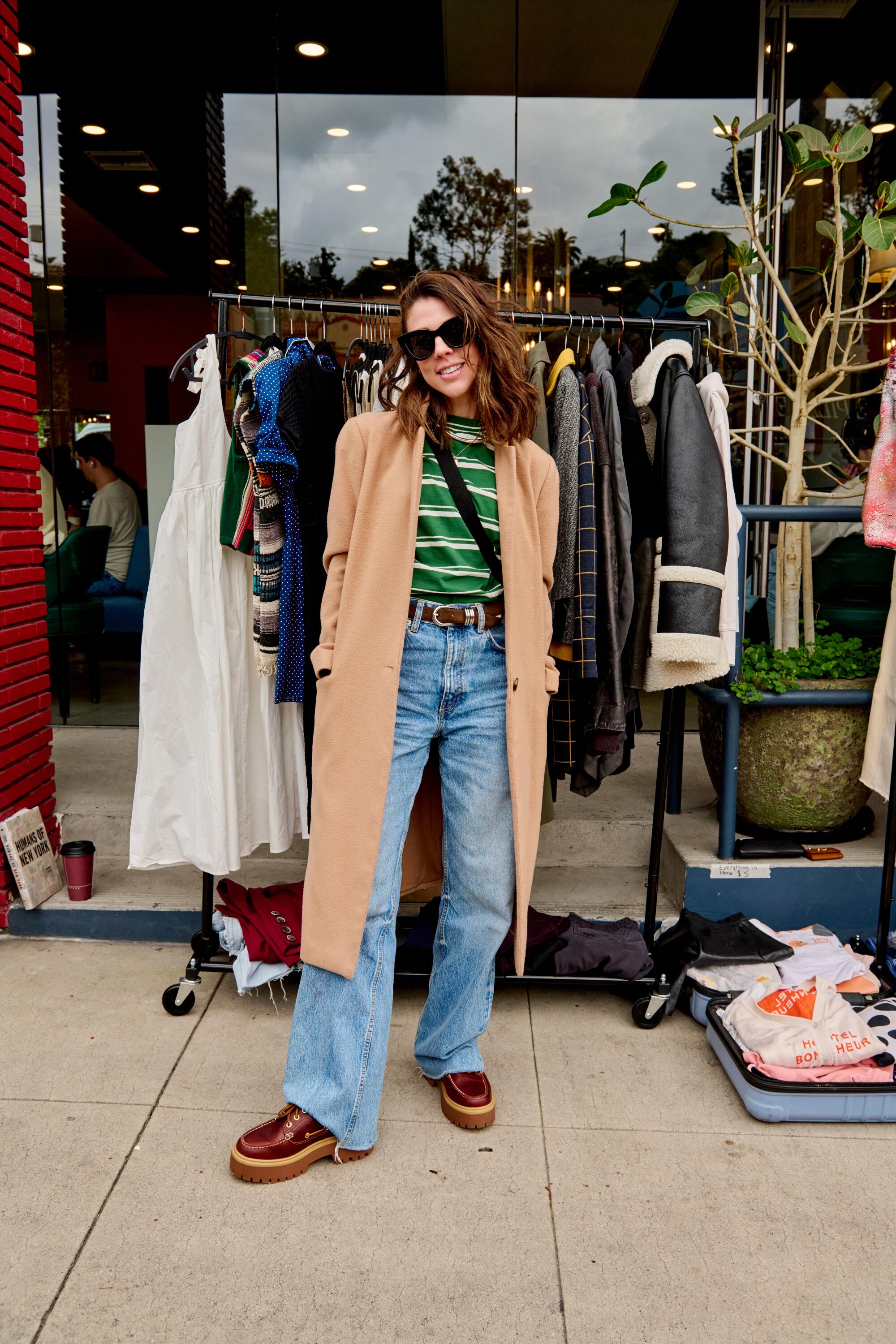 Kate Mansi in front of her closet rack.