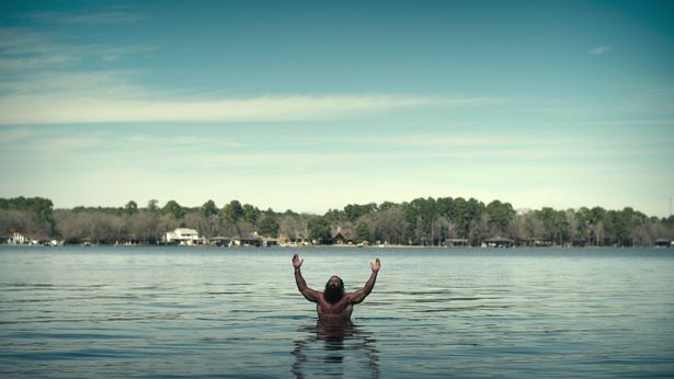 Liver King emerges from a blue lake, again topless