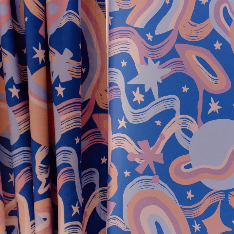 Decorative curtains and wallpaper featured in a room at the Trixie Motel.