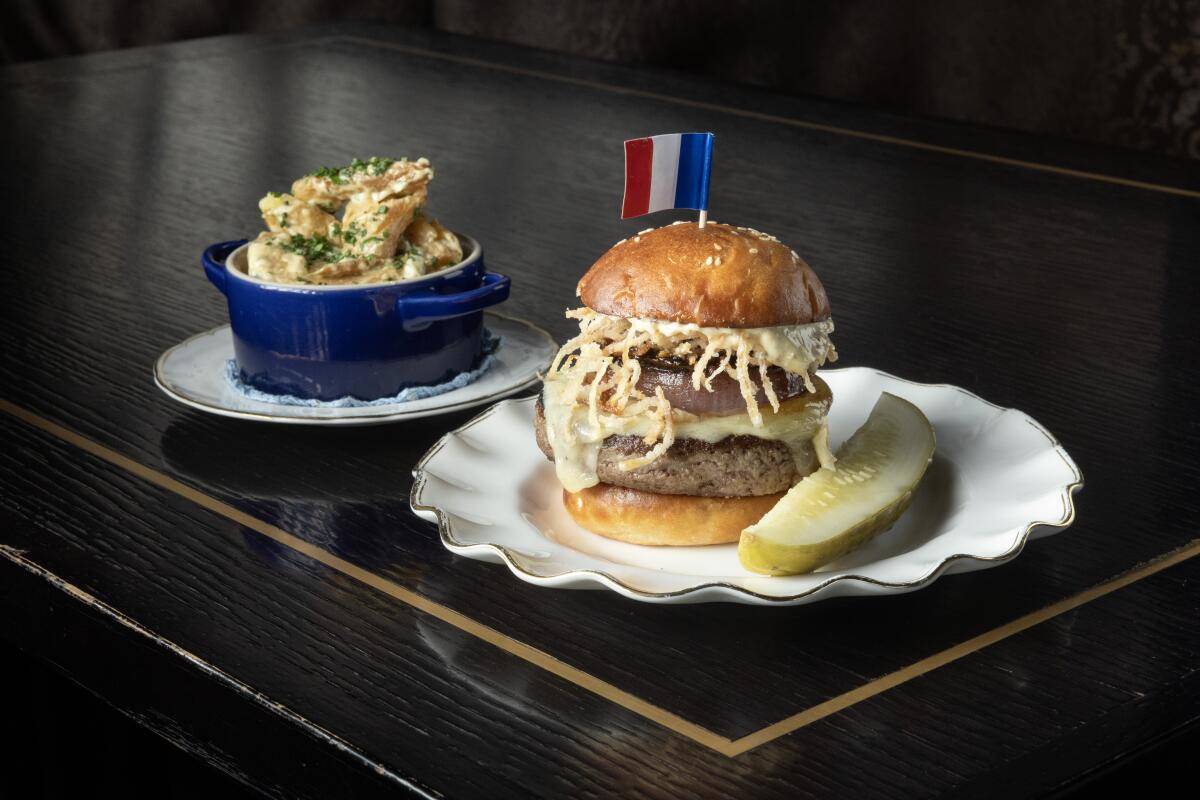 SANTA MONICA, CA - OCT 9 2024: Pasjoli burger with dry-aged beef, white cheddar, red onion "au poivre," marrow aioli