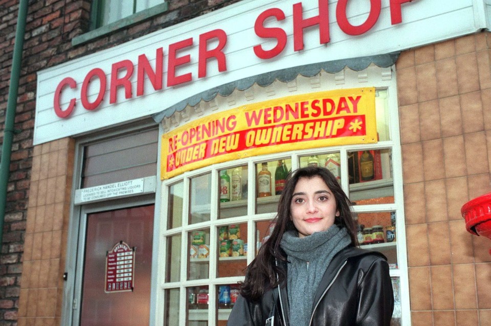 Rebecca Sarker as Nita Desai in Coronation Street, standing outside a corner shop.