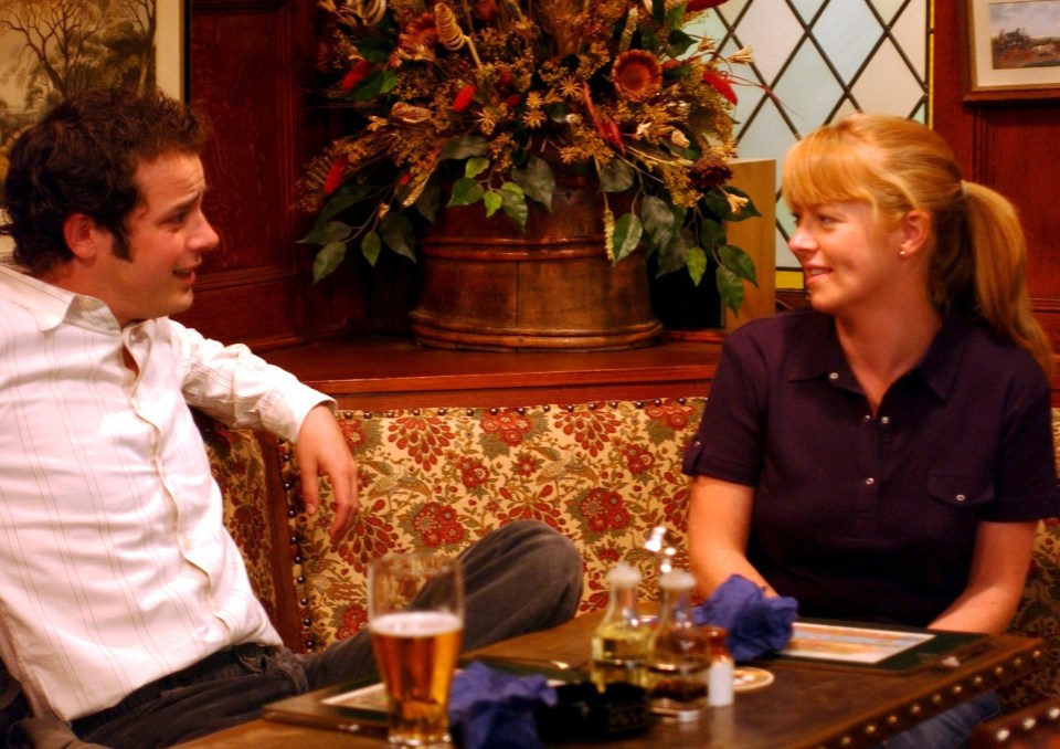 Max King trying to charm Sandra Briggs in a pub scene from Emmerdale.