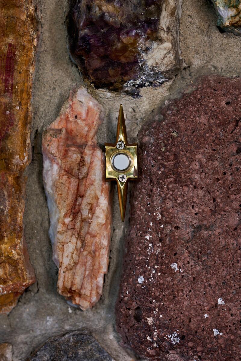 A detail of a rock facade with doorbell at the Pearl in San Diego