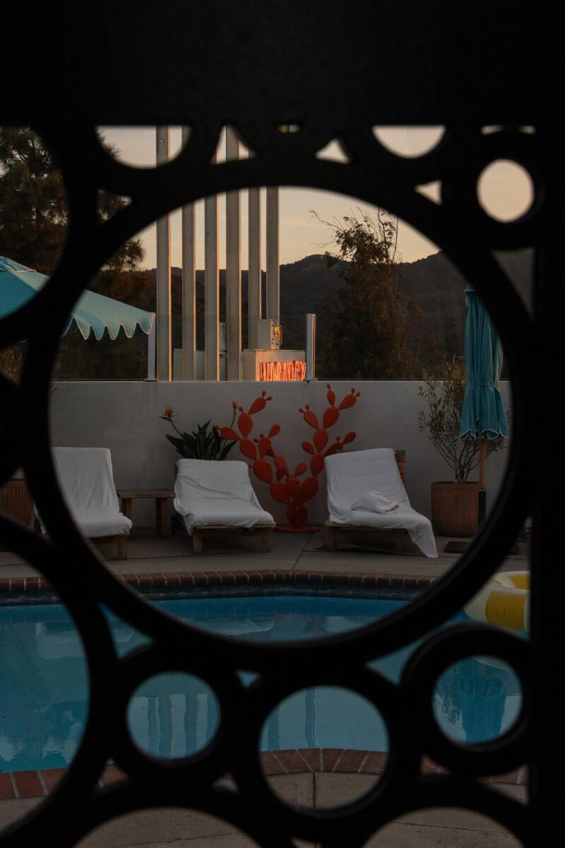 The pool viewed through decorative pool-side furnishings at the Skyview Motel.