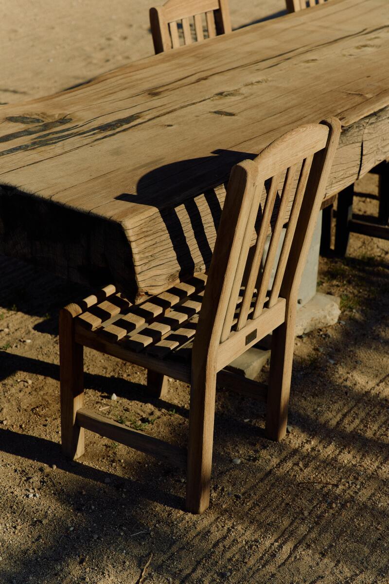 A wooden outdoor patio chair at the Mojave Sands Motel in Joshua Tree.
