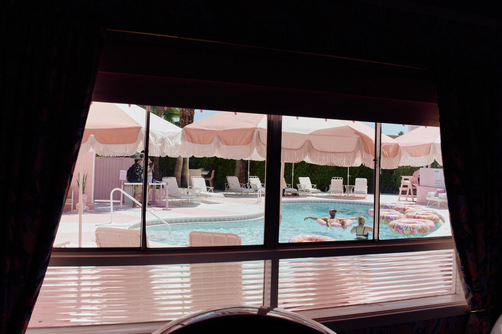 A view of the pool from inside the property at the Trixie Motel in Palm Springs.