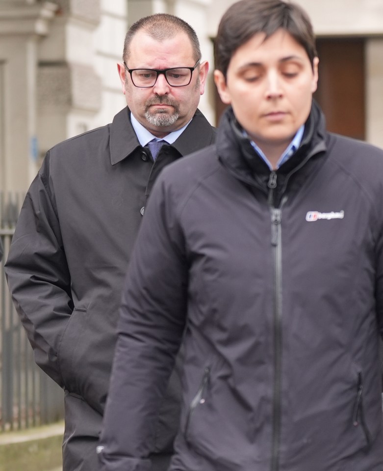 Two police officers leaving Westminster Magistrates' Court.