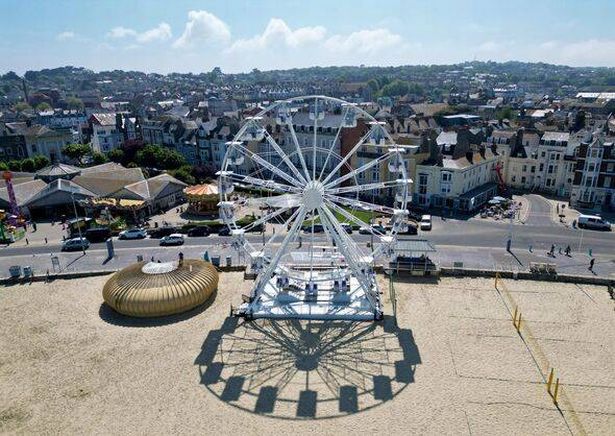 The Weymouth Observation Wheel is situated near other amusements on the beach
