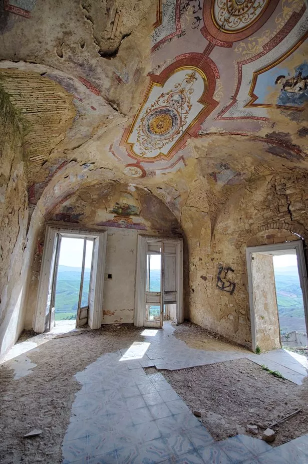 Shot from interior of building in Craco, showing intricate tiled ceiling design