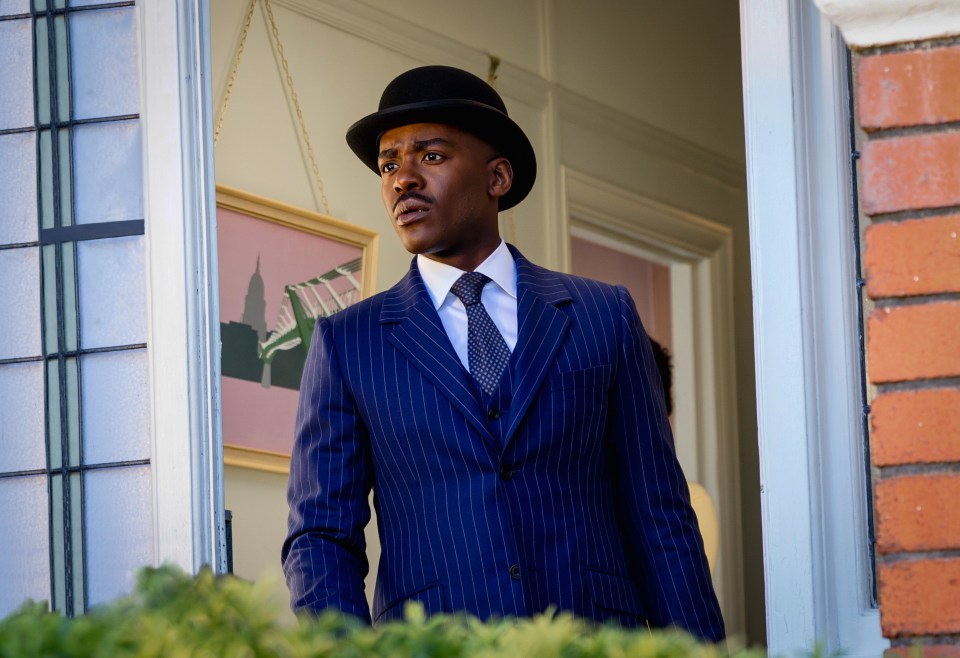 Ncuti Gatwa as the Doctor in a blue pinstripe suit and bowler hat.