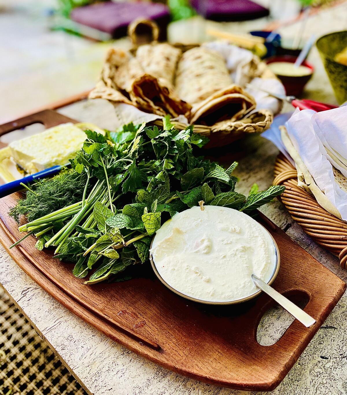 The shallot yogurt dip mast-o musir with fresh herbs and French feta and a basket of the Persian flatbread sangak.