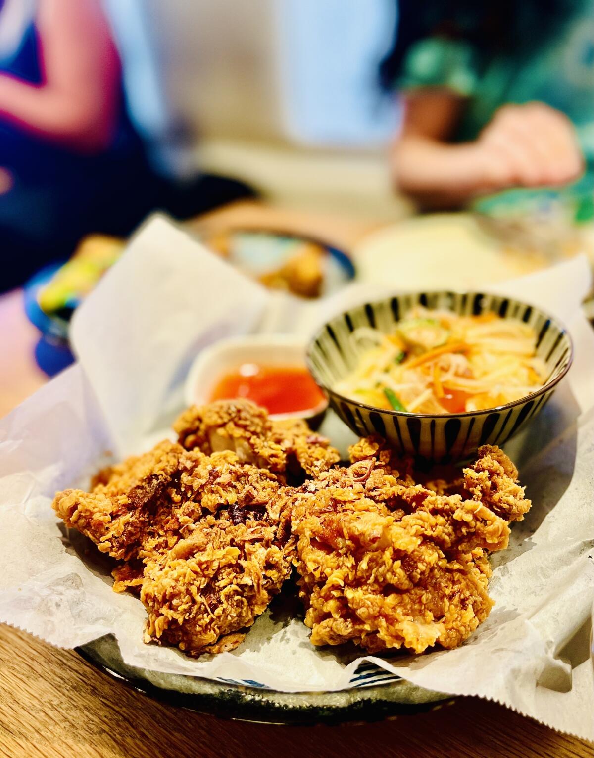 Thai fried chicken with papaya salad at Miya Thai restaurant in Altadena.