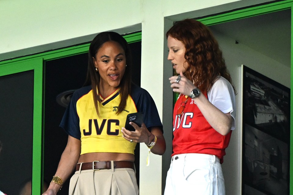 Alex Scott and Jess Glynne at a soccer match.