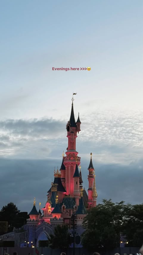 Sleeping Beauty Castle at Disneyland Paris at dusk.