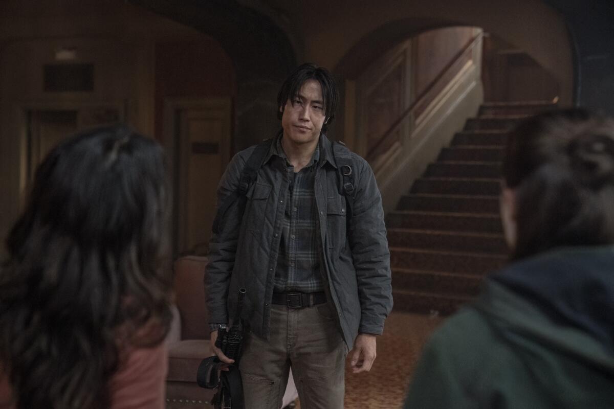 Young Mazino holding a rifle