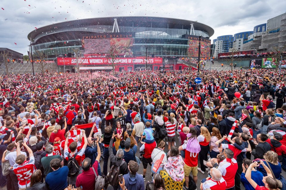 Arsenal Women fans celebrating their UEFA Women's Champions League victory outside the Emirates Stadium.
