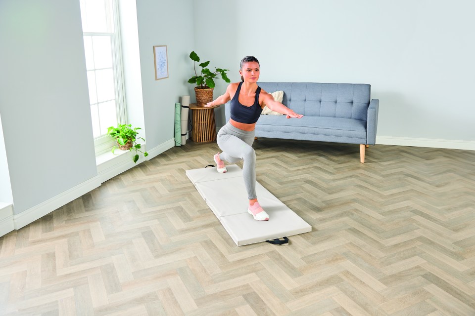 Woman doing a yoga pose on a mat.