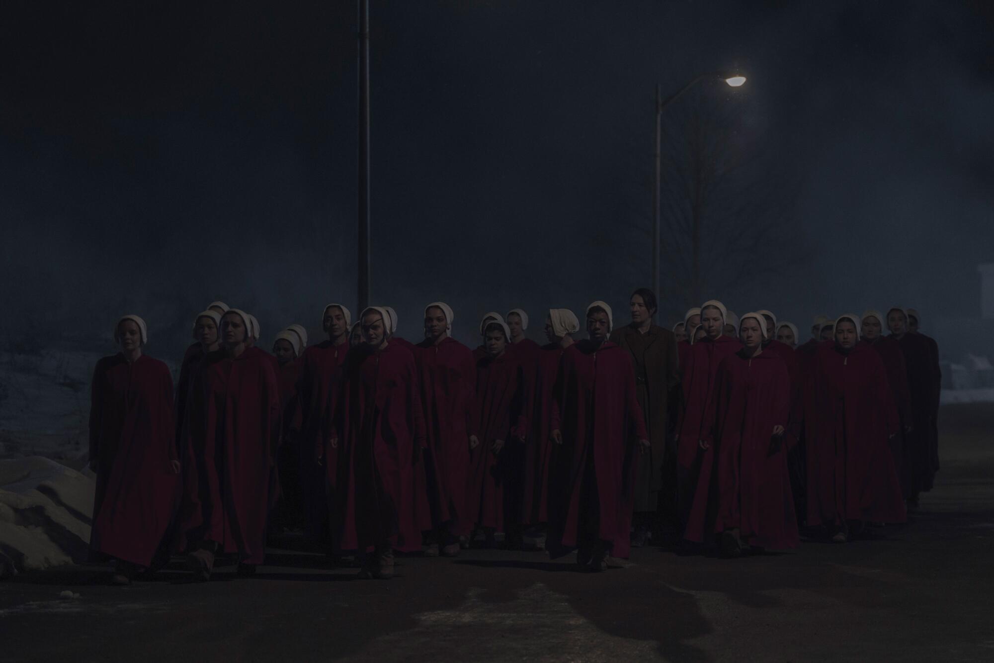 A group of women in red robes