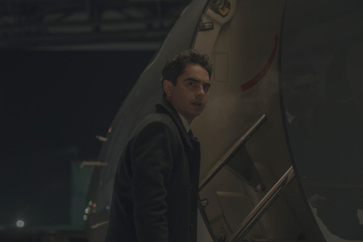A man stares to the distance before boarding a plan