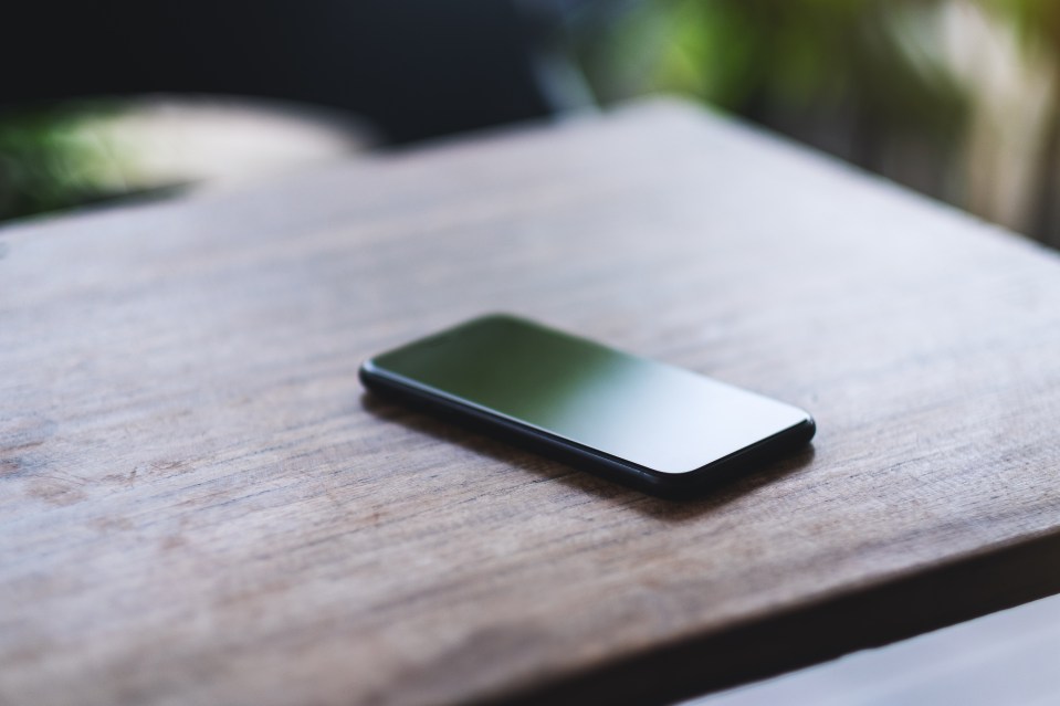 Smartphone on wooden table.