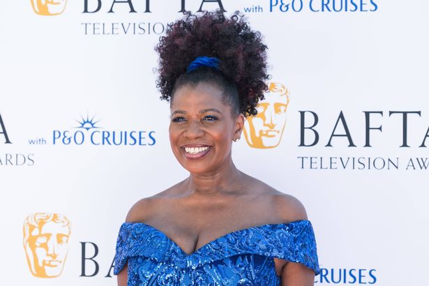 Brenda Edwards in a blue dress