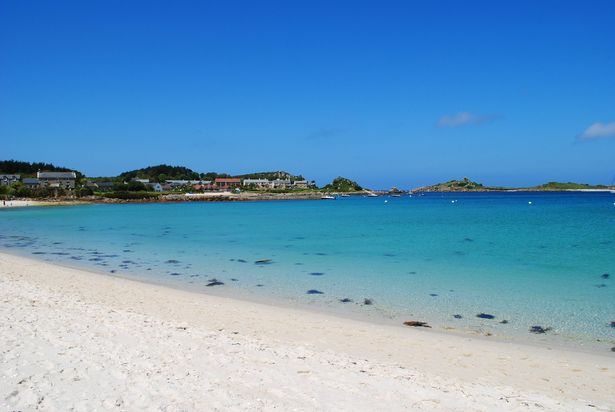 The beautiful white sands and blue sea of Tresco Island, park of the Isles of Scilly, UK.  Looking out across the water to St. Martin's Island.