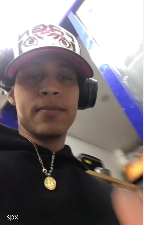 Close-up photo of a young man wearing a hat and headphones.