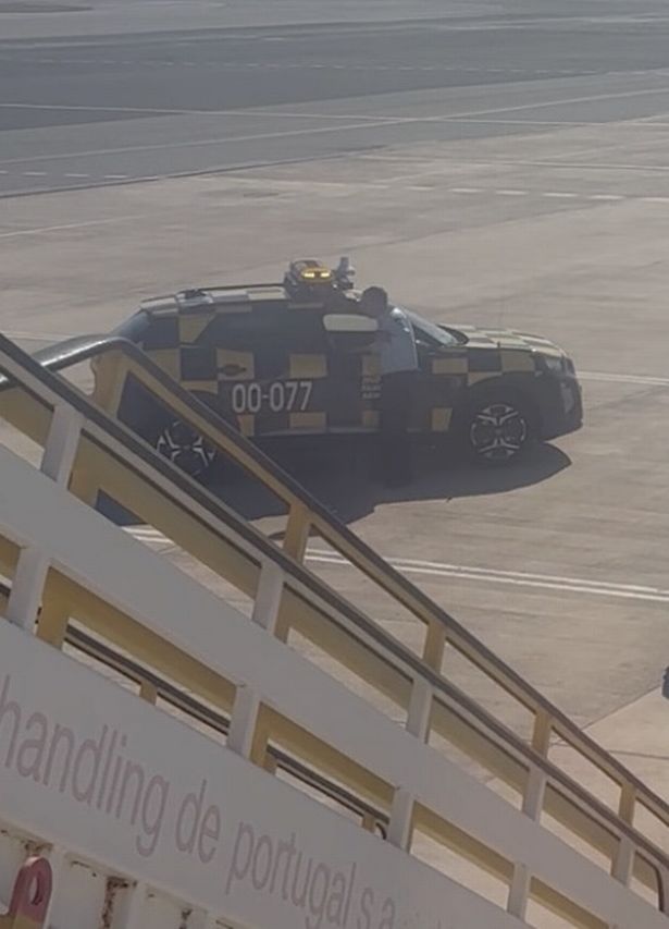 Two men were taken off the plane, and four others left voluntarily
