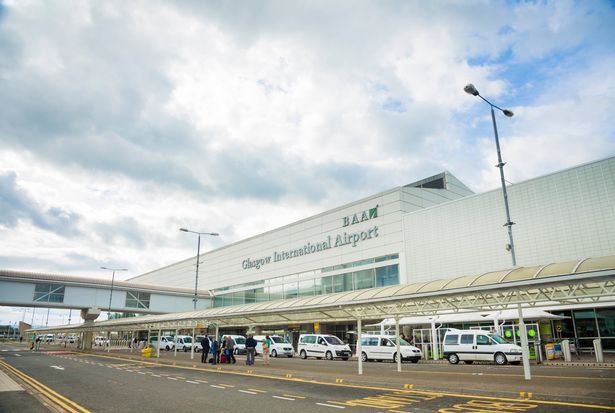 Glasgow, UK - August 13, 2013: Arriving passengers and taxis outside the main terminal of Glasgow Airport. Glasgow Airport is operated by Heathrow Airport Holdings, previously known as British Airports Authority.
