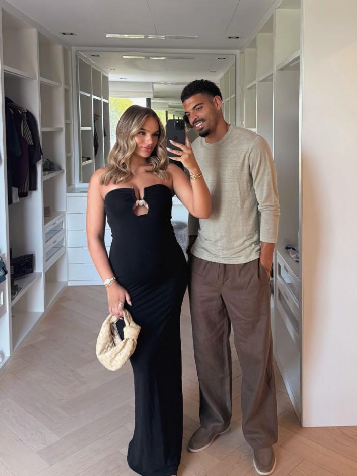 Couple taking a selfie in a walk-in closet.
