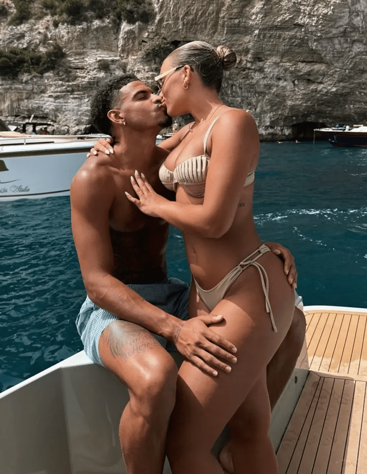 Couple kissing on a boat.