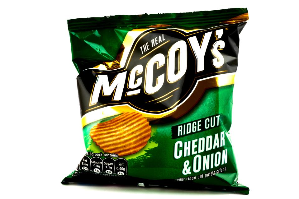 Bag of McCoy's Cheddar & Onion ridge cut crisps.