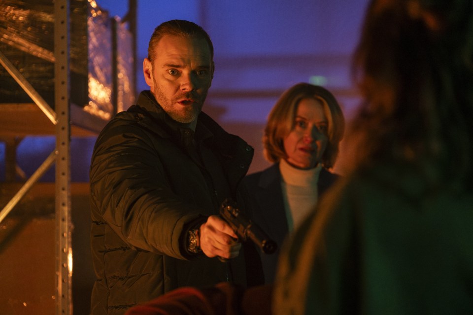 Scene from the ITV crime drama *Code of Silence*, showing a man pointing a gun.