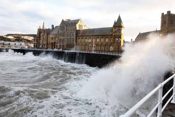 Christmas Eve, High Tide at Aberystwyth, with Old College in background.