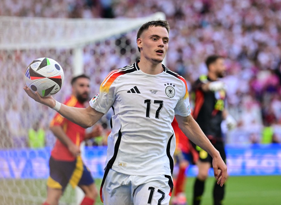 Soccer player holding a ball.