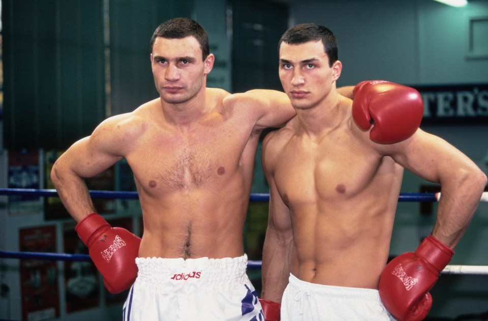 Vitali and Wladimir Klitschko, brothers and heavyweight boxers, posing together in boxing gloves and shorts.