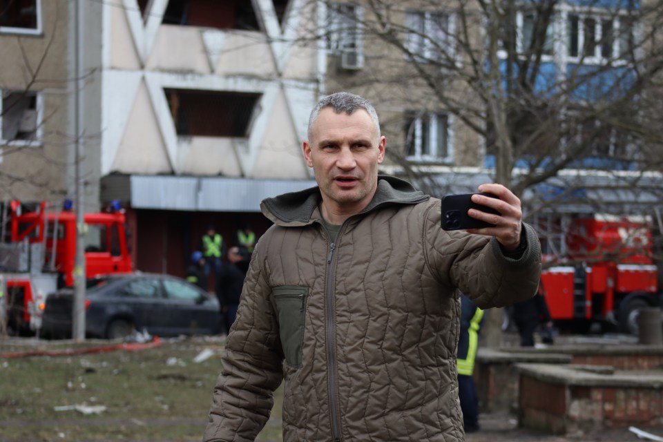 Kyiv mayor Vitali Klitschko recording a video near a damaged building after a missile attack.