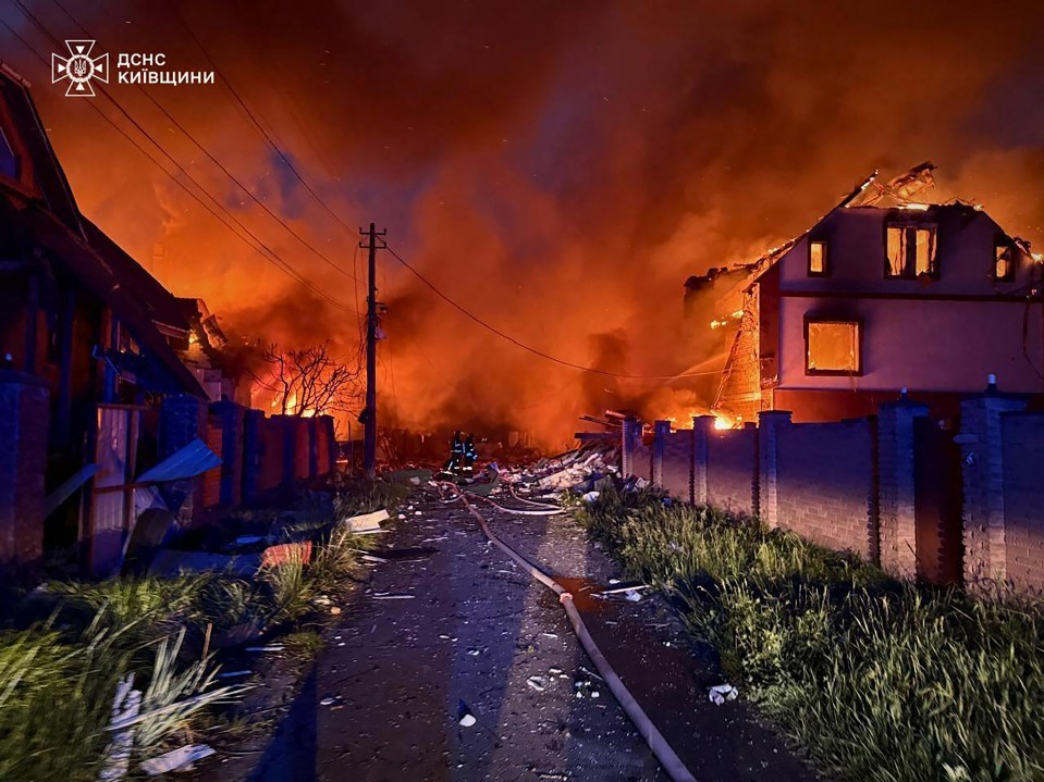 Firefighters battling a fire at burning houses in the Kyiv region.