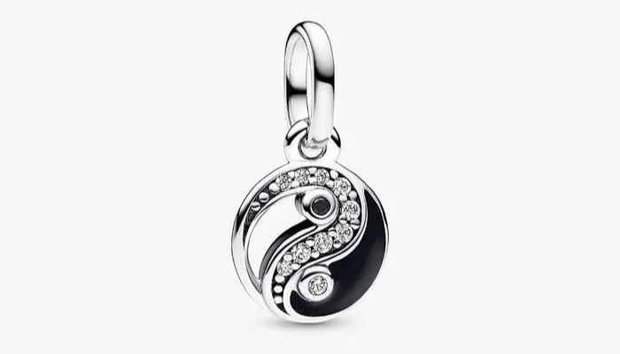 Yin and yang charm with clear and black enamel.
