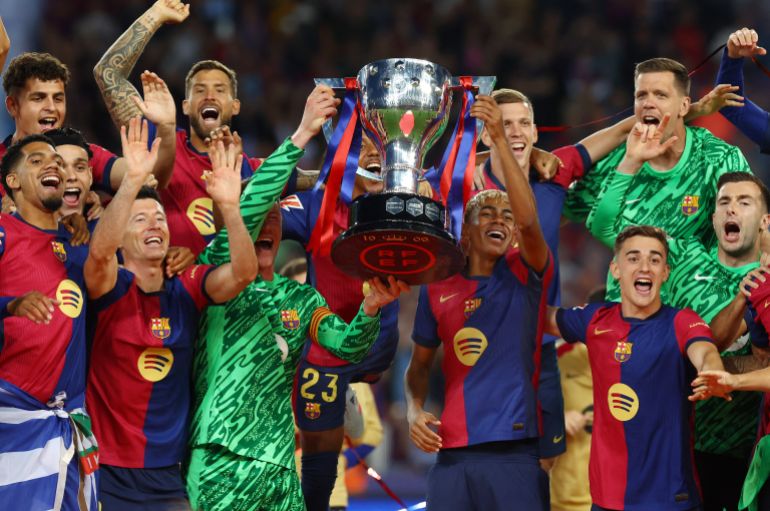 Barcelona's Lamine Yamal and FC Barcelona's Marc-Andre ter Stegen lift the trophy after winning LaLiga