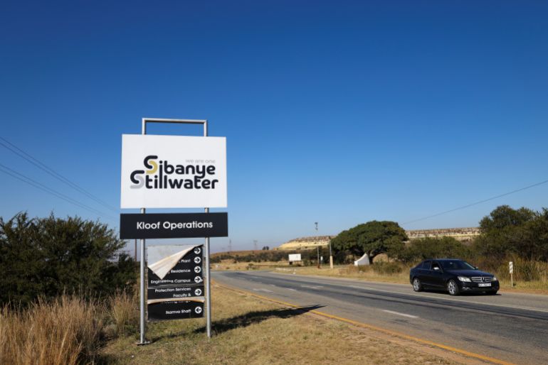 A car drives past the Sibanye Stillwater logo,