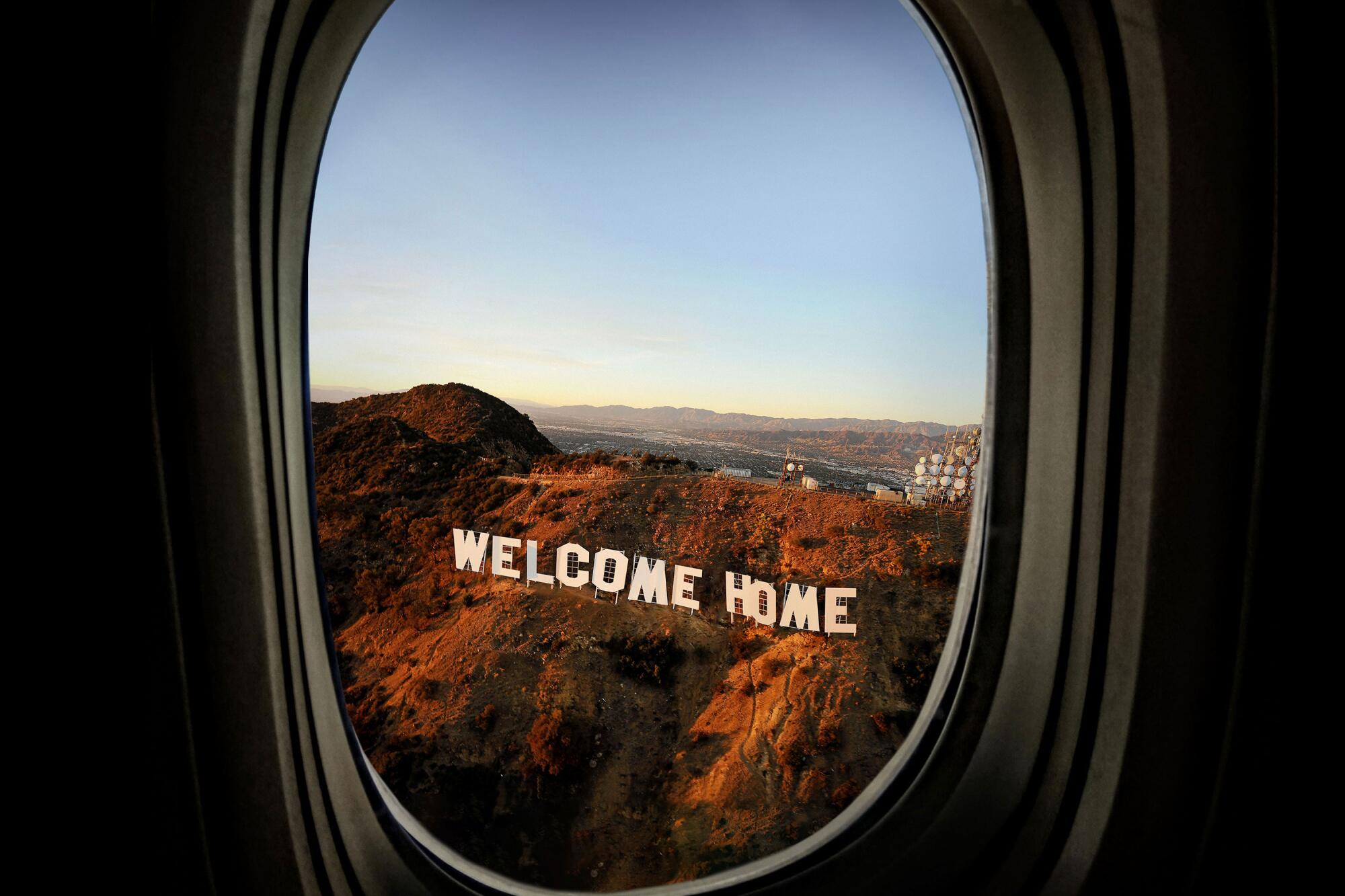 View from an airplane window of the Hollywood sign, altered to read: WELCOME HOME.