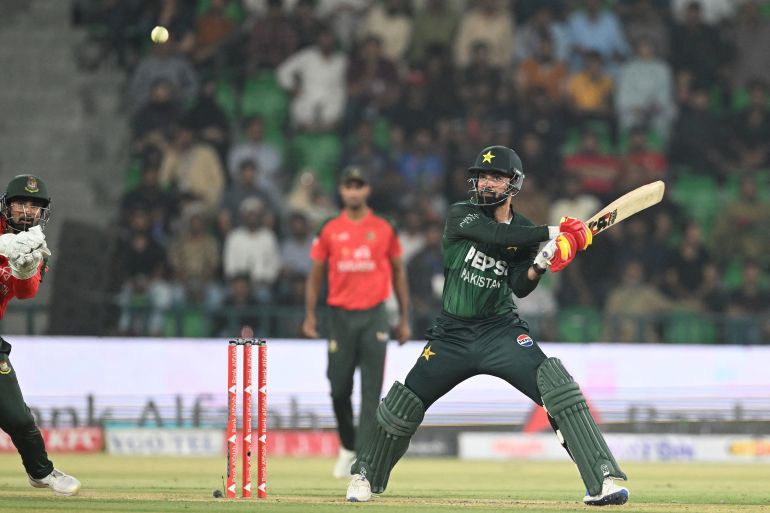 Pakistan's Shadab Khan (R) plays a shot during the first Twenty20 international cricket match between Pakistan and Bangladesh at the Gaddafi Cricket Stadium in Lahore on May 28, 2025. (Photo by Aamir QURESHI / AFP)
