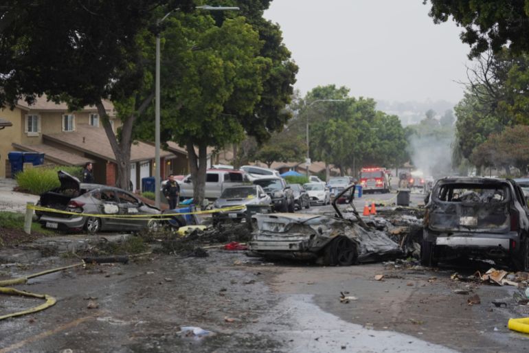 Charred cars after a plane crash in a residential area
