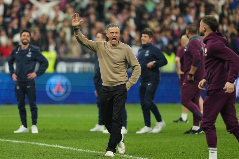 PSG's head coach Luis Enrique, centre, celebrates at the end of the French Cup soccer final